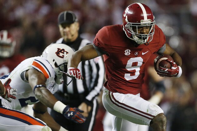 Alabama wide receiver Amari Cooper (9) runs against Auburn defensive back Johnathan Ford (23) during the second half of the Iron Bowl NCAA college football game, Saturday, Nov. 29, 2014, in Tuscaloosa, Ala. (AP Photo/Brynn Anderson)