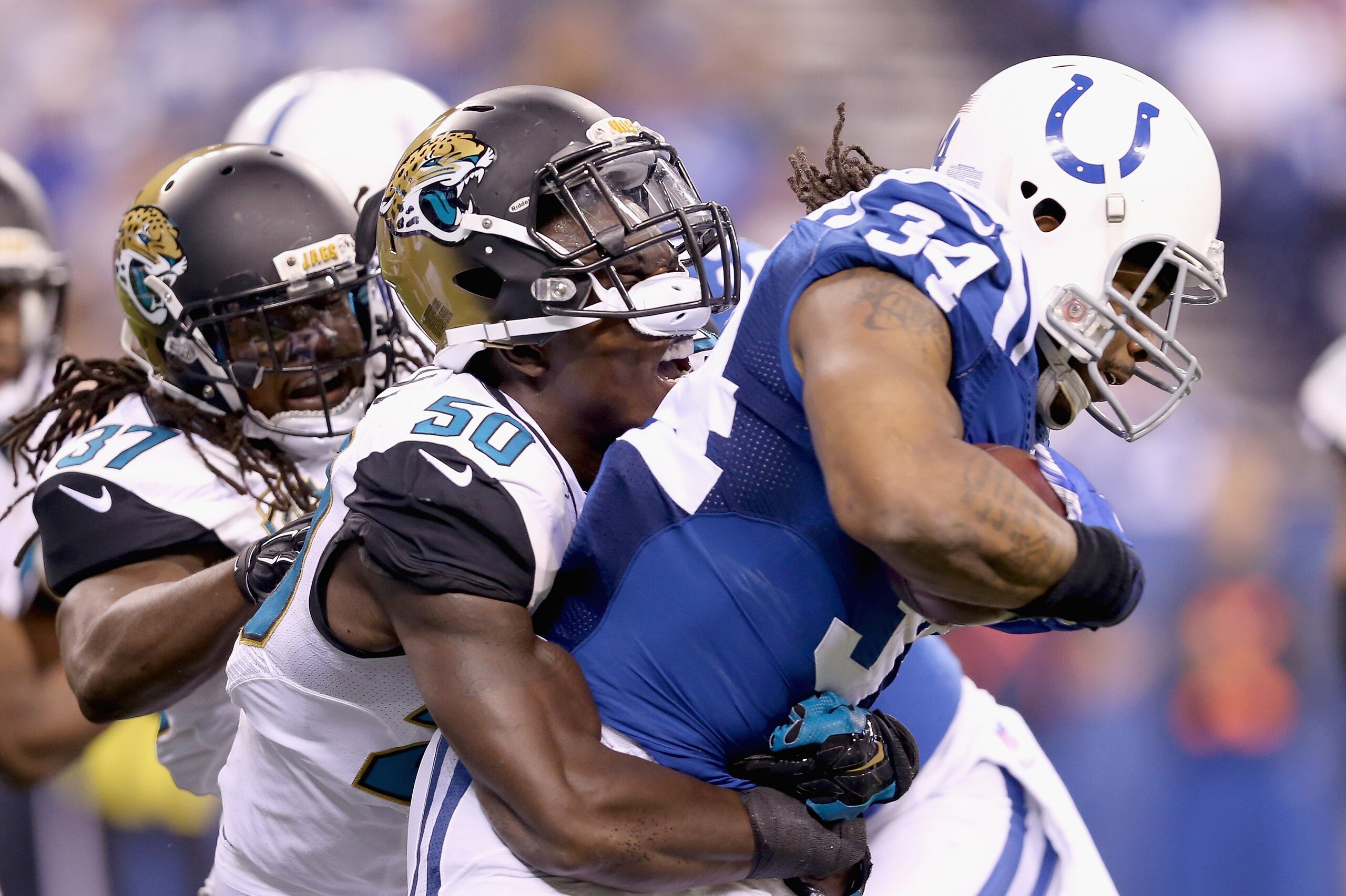 INDIANAPOLIS, IN - NOVEMBER 23: Trent Richardson #34 of the Indianapolis Colts runs with the ball while tackled by Telvin Smith #50 of the Jacksonville Jaguars during the game at Lucas Oil Stadium on November 23, 2014 in Indianapolis, Indiana. (Photo by Andy Lyons/Getty Images) INDIANAPOLIS, IN - NOVEMBER 23: Trent Richardson #34 of the Indianapolis Colts runs with the ball while tackled by Telvin Smith #50 of the Jacksonville Jaguars during the game at Lucas Oil Stadium on November 23, 2014 in Indianapolis, Indiana. (Photo by Andy Lyons/Getty Images)