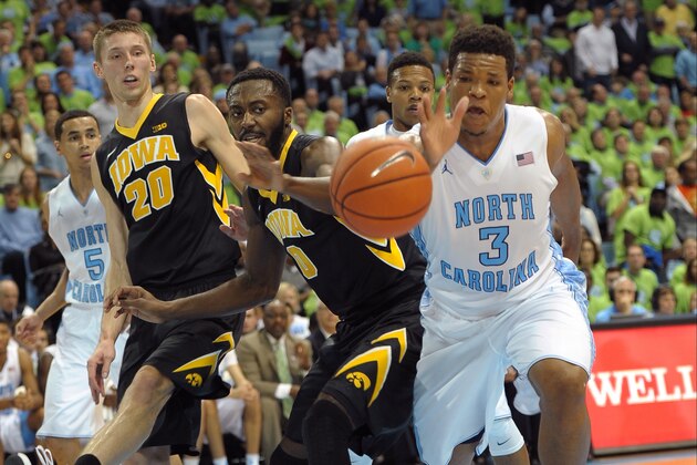 CHAPEL HILL, NC - DECEMBER 03: Gabriel Olaseni #0 of the Iowa Hawkeyes and Kennedy Meeks #3 of the North Carolina Tar Heels try to reach a loose ball during a game at the Dean Smith Center on December 3, 2014 in Chapel Hill, North Carolina. (Photo by Lance King/Getty Images)