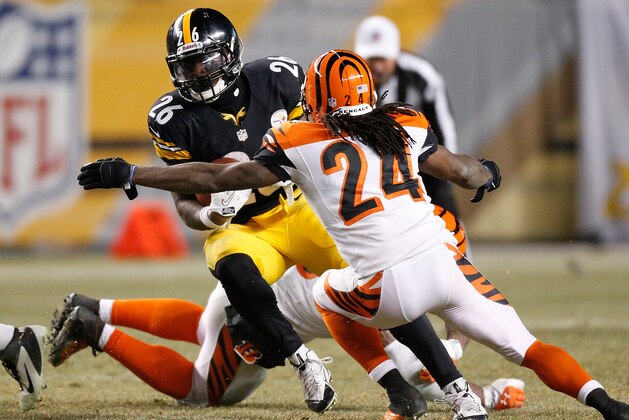 PITTSBURGH, PA - DECEMBER 15: Le'Veon Bell #26 of the Pittsburgh Steelers tries to get around the tackle of Adam Jones #24 of the Cincinnati Bengals during a fourth quarter run at Heinz Field on December 15, 2013 in Pittsburgh, Pennsylvania. Pittsburgh won the game 30-20. (Photo by Gregory Shamus/Getty Images)