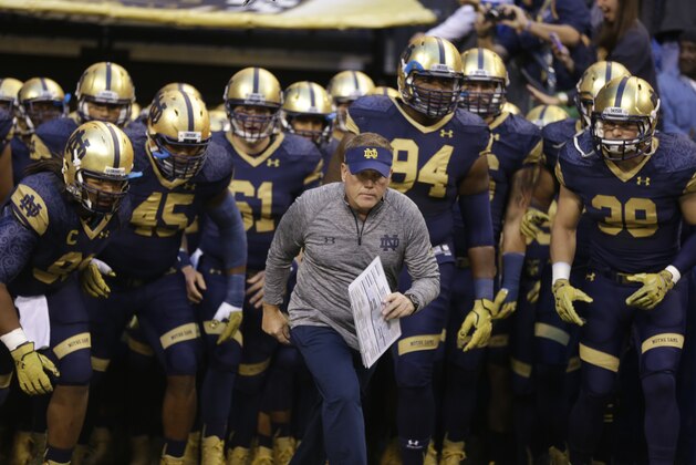 Notre Dame head coach Brian Kelly takes the field with his team before an NCAA college football game against Purdue in Indianapolis, Saturday, Sept. 13, 2014. (AP Photo/Michael Conroy)