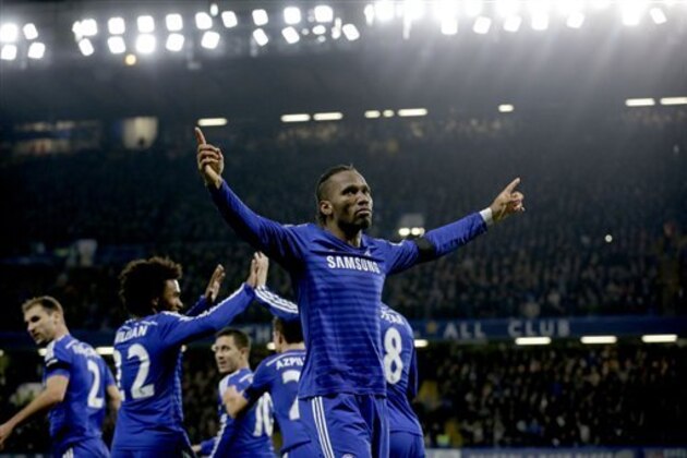 Chelsea's Didier Drogba, right, celebrates scoring his side's second goal during the English Premier League soccer match between Chelsea and Tottenham Hotspur at Stamford Bridge stadium in London, Wednesday, Dec. 3, 2014.  (AP Photo/Matt Dunham)