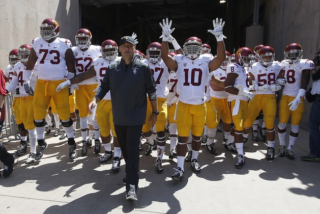 Southern California head coach Steve Sarkisian leads his team onto the field during an NCAA college football game against Stanford on Saturday, Sept. 6, 2014, in Stanford, Calif. (AP Photo/Tony Avelar)