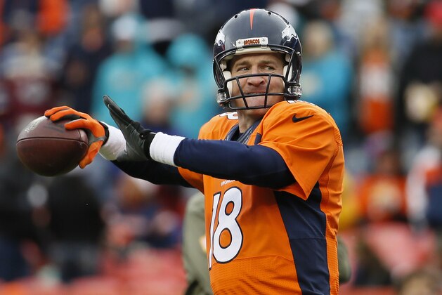 Denver Broncos quarterback Peyton Manning (18) warms up prior to an NFL football game against the Miami Dolphins, Sunday, Nov. 23, 2014, in Denver. (AP Photo/Jack Dempsey)