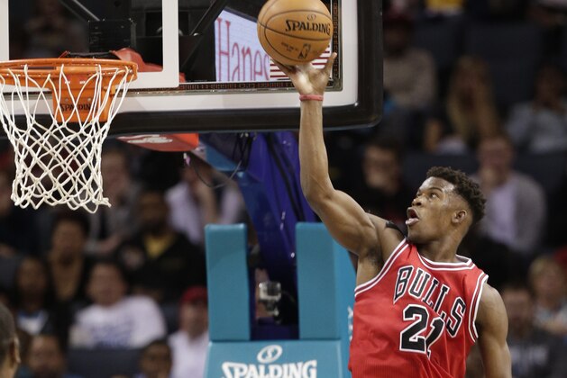 Chicago Bulls' Jimmy Butler (21) goes to the basket against the Charlotte Hornets during the first half of an NBA basketball game in Charlotte, N.C., Wednesday, Dec. 3, 2014. (AP Photo/Chuck Burton)