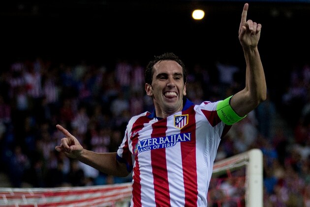 MADRID, SPAIN - OCTOBER 22:  Diego Godin of Atletico de Madrid jumps celebrating scoring their fourth goal during the UEFA Champions League group A match between Club Atletico de Madrid and Malmo FF at Vicente Calderon stadium on October 22, 2014 in Madrid, Spain.  (Photo by Gonzalo Arroyo Moreno/Getty Images)