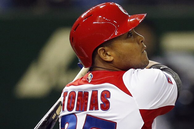 FILE - In this March 9, 2013, file photo, Cuba's Yasmany Tomas hits a three-run home run off Taiwan pitcher Yang Yao-hsun in the fourth inning of their World Baseball Classic second-round game in Tokyo. A person familiar with the negotiations says Tomas is in the process of agreeing to a $68.5 million, six-year contract with the Arizona Diamondbacks.  The person spoke on condition of anonymity Wednesday, Nov. 26, 2014, because the deal had not yet been completed. The person said several additional steps were necessary but the agreement was likely to be finalized in the next few days. (AP Photo/Koji Sasahara, File)