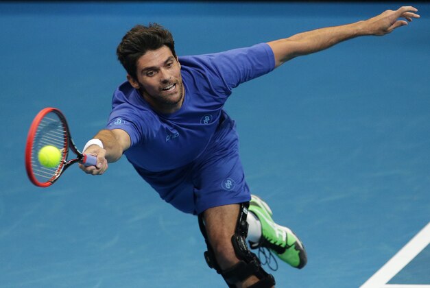 Manila Mavericks Mark Philippoussis returns the ball against Singapore Slammers Patrick Rafter during their IPTL (International Premier Tennis League) Past Champions Singles match on Sunday, Nov. 30, 2014 at the Mall of Asia Arena in suburban Pasay city, south of Manila, Philippines. The IPTL, featuring four teams, introduces a new format in tennis and a chance for a championship prize of $1-million dollars. Philippoussis won the match. (AP Photo/Aaron Favila)