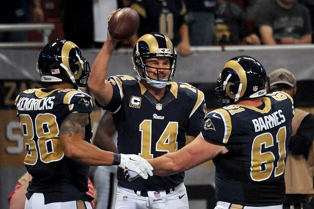 St. Louis Rams quarterback Shaun Hill, center, is congratulated by Lance Kendricks, left, and Tim Barnes after scoring on a 2-yard touchdown run during the first quarter of an NFL football game against the Oakland Raiders, Sunday, Nov. 30, 2014, in St. Louis. (AP Photo/L.G. Patterson)