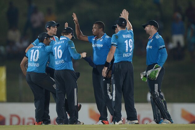 HAMBANTOTA, SRI LANKA - DECEMBER 03: Chris Jordan of England celebrates with teammates after dismissing Kumar Sangakkara of Sri Lanka during the 3rd One Day International between Sri Lanka and England at Mahinda Rajapaksa International Stadium on December 3, 2014 in Hambantota, Sri Lanka.  (Photo by Gareth Copley/Getty Images)