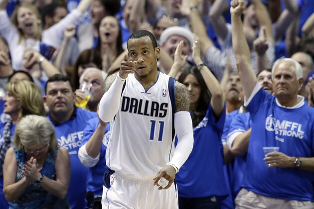 Fans cheer as Dallas Mavericks' Monta Ellis (11) celebrates after scoring and being fouled by the San Antonio Spurs in the second half of Game 6 of an NBA basketball first-round playoff series on Friday, May 2, 2014, in Dallas. The Mavericks won 113-111. (AP Photo/Tony Gutierrez)