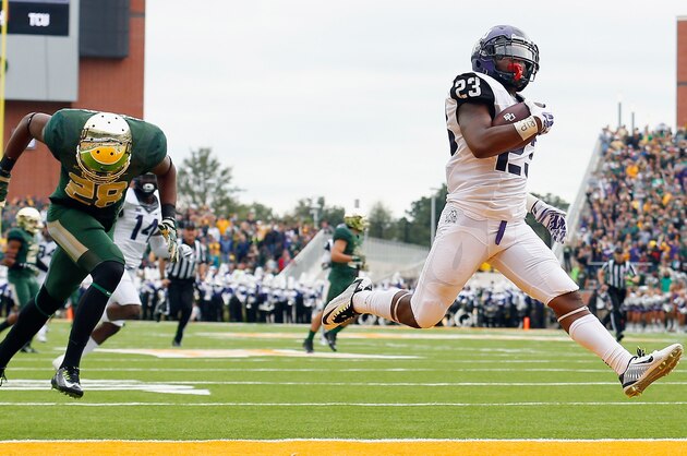 WACO, TX - OCTOBER 11:  B.J. Catalon #23 of the TCU Horned Frogs returns a kickoff for a touchdown against Orion Stewart #28 of the Baylor Bears in the first half at McLane Stadium on October 11, 2014 in Waco, Texas.  (Photo by Tom Pennington/Getty Images)