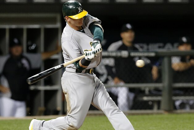Oakland Athletics' Josh Donaldson hits a two-run double off Chicago White Sox starting pitcher John Danks, scoring Coco Crisp and pinch runner Josh Reddick, during the fifth inning of a baseball game Tuesday, Sept. 9, 2014, in Chicago. (AP Photo/Charles Rex Arbogast)