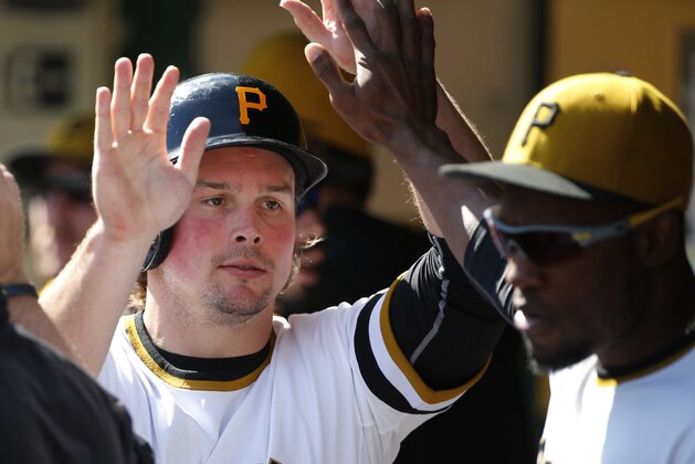 Pittsburgh Pirates' Travis Snider, left, celebrates with Starling Marte after scoring during a baseball game against the Chicago Cubs in Pittsburgh Sunday, Sept. 14, 2014. (AP Photo/Gene J. Puskar)