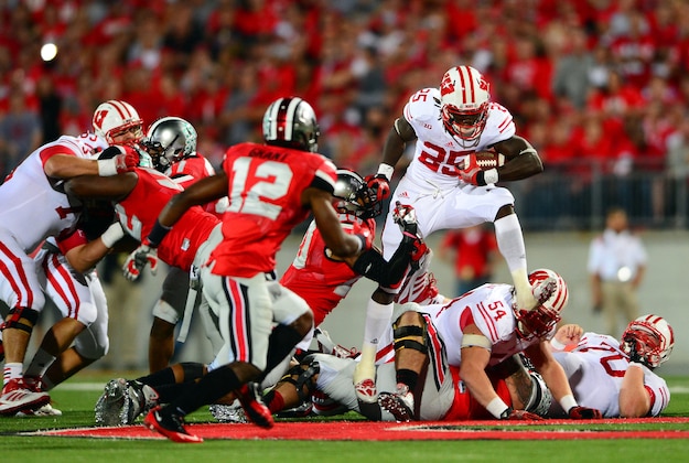 Sep 28, 2013; Columbus, OH, USA; Wisconsin Badgers running back Melvin Gordon (25) jumps over the line of scrimmage during the second quarter against the Ohio State Buckeyes at Ohio Stadium. Mandatory Credit: Andrew Weber-USA TODAY Sports
