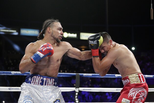 Julio Diaz, right, takes a punch from Keith Thurman during the third round of a WBA interim welterweight title boxing match on Saturday, April 26, 2014, in Carson, Calif. Thurman won by TKO after the third round. Diaz wasn't able to come out for the fourth round due to his rib injury.(AP Photo/Jae C. Hong)