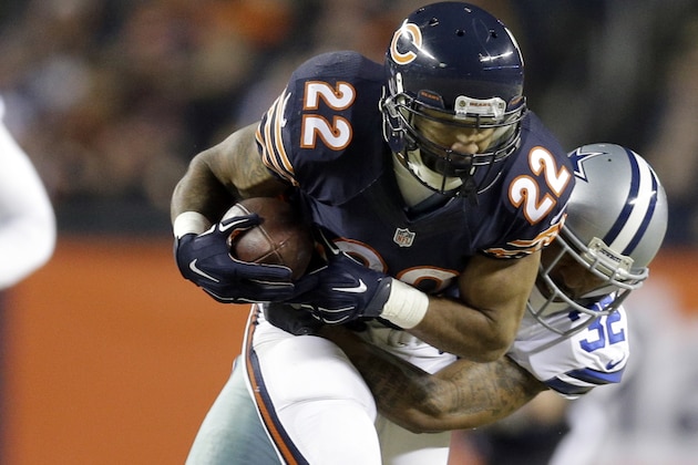 Dallas Cowboys cornerback Orlando Scandrick (32) tackles Chicago Bears running back Matt Forte (22) during the first half of an NFL football game Thursday, Dec. 4, 2014, in Chicago. (AP Photo/Nam Y. Huh)