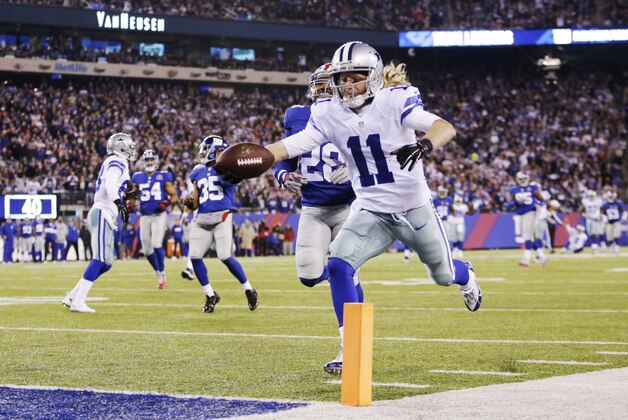 Dallas Cowboys wide receiver Cole Beasley (11) reaches for the goal line as he runs the ball for a touchdown against the New York Giants in the third quarter of an NFL football game, Sunday, Nov. 23, 2014, in East Rutherford, N.J. (AP Photo/Kathy Willens)