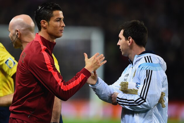 MANCHESTER, ENGLAND - NOVEMBER 18:  Cristiano Ronaldo of Portugal shakes hands with Lionel Messi of Argentina prior to the International Friendly between Argentina and Portugal at Old Trafford on November 18, 2014 in Manchester, England.  (Photo by Laurence Griffiths/Getty Images)