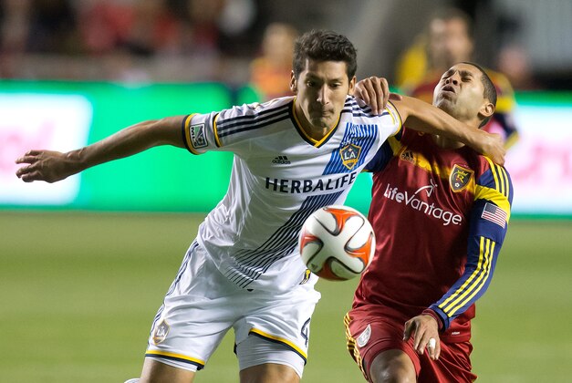 Nov 1, 2014; Sandy, UT, USA; Los Angeles Galaxy defender Omar Gonzalez (4) fouls Real Salt Lake forward Alvaro Saborio (15) during the second half at Rio Tinto Stadium. The match ended in a 0-0 draw. Mandatory Credit: Russ Isabella-USA TODAY Sports