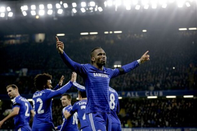Chelsea's Didier Drogba, right, celebrates scoring his side's second goal during the English Premier League soccer match between Chelsea and Tottenham Hotspur at Stamford Bridge stadium in London, Wednesday, Dec. 3, 2014.  (AP Photo/Matt Dunham)
