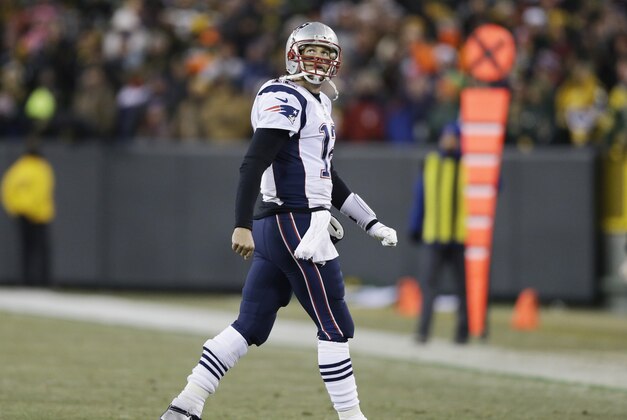 New England Patriots' Tom Brady looks back as he walks off the field during the second half of an NFL football game against the Green Bay Packers Sunday, Nov. 30, 2014, in Green Bay, Wis. The Packers won 26-21. (AP Photo/Tom Lynn)