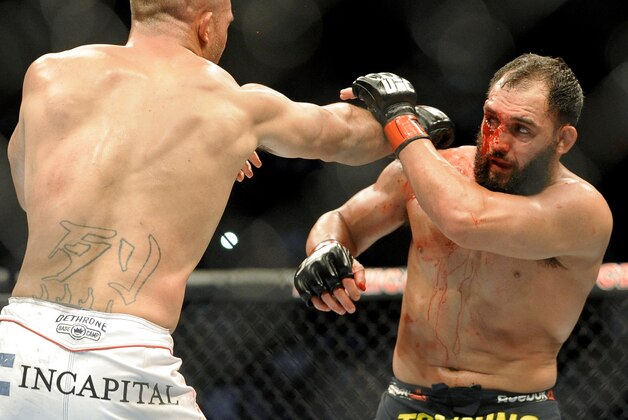 Johny Hendricks blocks a punch from Robbie Lawler during a UFC 171 mixed martial arts welterweight title bout, Saturday, March 15, 2014, in Dallas. Hendricks won by decision. (AP Photo/Matt Strasen)