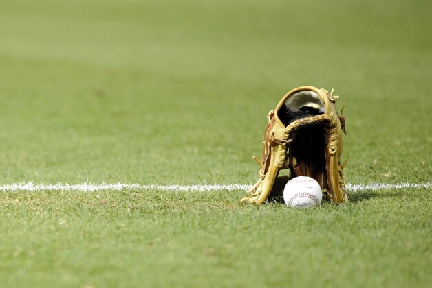 Jun 21, 2014; Phoenix, AZ, USA; A baseball and fielder's glove sit on the field before the start of the game between the Arizona Diamondbacks and the San Francisco Giants at Chase Field. Mandatory Credit: Joe Camporeale-USA TODAY Sports
