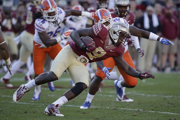 Florida State running back Karlos Williams (9) gains yardage against Florida during the first half of an NCAA college football game in Tallahassee, Fla., Saturday, Nov. 29, 2014. (AP Photo/John Raoux)