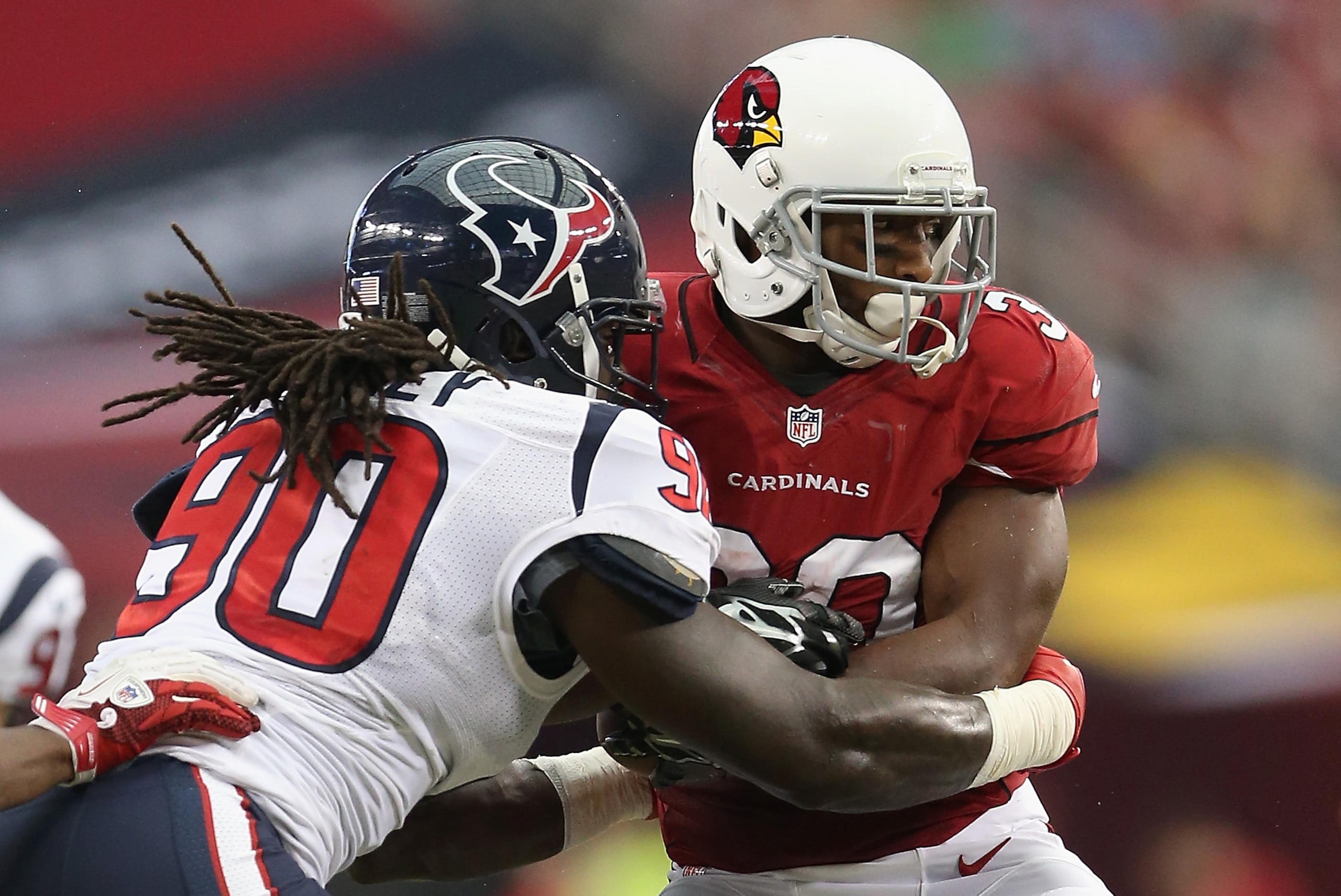 GLENDALE, AZ - AUGUST 09:  Linebacker Jadeveon Clowney #90 of the Houston Texans tackles running back Stepfan Taylor #30 of the Arizona Cardinals for a loss during the preseason NFL game at the University of Phoenix Stadium on August 9, 2014 in Glendale, Arizona.  (Photo by Christian Petersen/Getty Images)