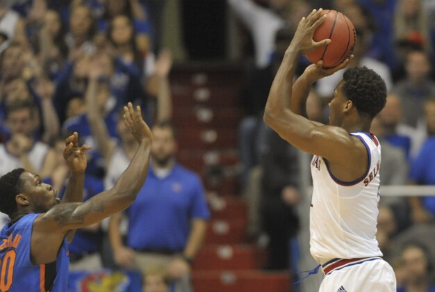 Dec 5, 2014; Lawrence, KS, USA; Kansas Jayhawks guard Wayne Selden Jr. (1) shoots a three point shot as Florida Gators guard Michael Frazier II (20) defends during the first half at Allen Fieldhouse. Mandatory Credit: Denny Medley-USA TODAY Sports