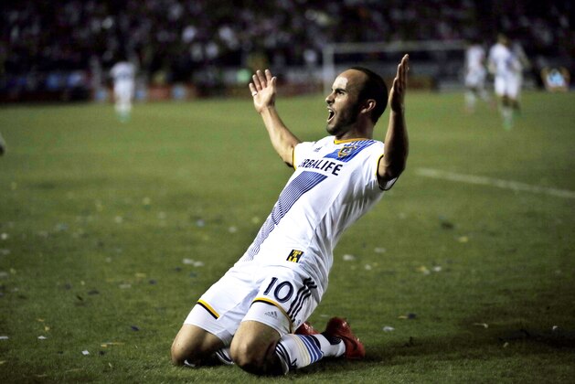 FILE - In this Nov. 9, 2014, file photo, Los Angeles Galaxy's Landon Donovan celebrates scoring a goal against Real Salt Lake during the second half of an MLS soccer Western Conference playoff series game, in Carson, Calif. Although Donovan ends his soccer career in the MLS Cup on Sunday, the LA Galaxy have resisted the notion they're trying to win a title as a parting gift for the greatest player in U.S. history. They've got plenty of motivation against the New England Revolution even without honoring Donovan.  (AP Photo/Danny Moloshok, File)
