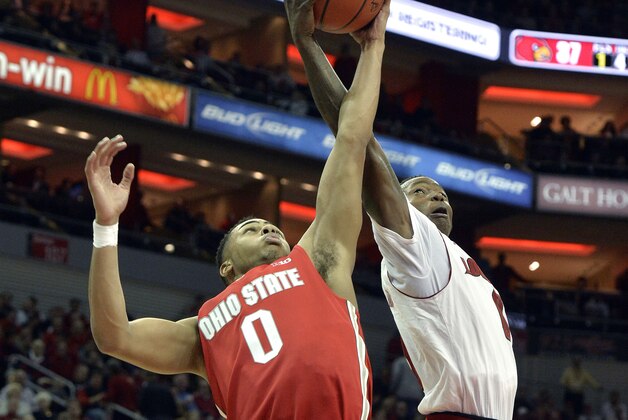 Louisville's Terry Rozier, right, battles Ohio State's D'Angelo Russell for a rebound during the second half of an NCAA college basketball game Tuesday, Dec. 2, 2014, in Louisville, Ky. Louisville won 64-55. (AP Photo/Timothy D. Easley)