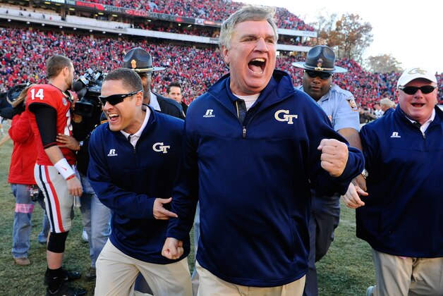 Georgia Tech head coach Paul Johnson, center, shouts and clenches his fist after their 30-24 win in overtime against Georgia in an NCAA college football game Saturday, Nov. 29, 2014, in Athens, Ga. (AP Photo/David Tulis)
