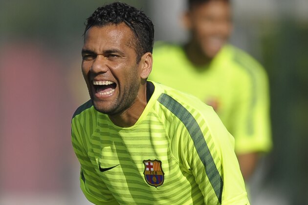 FC Barcelona's Dani Alves, from Brazil, laughs during a training session at the Sports Center FC Barcelona Joan Gamper in San Joan Despi, Spain, Monday, Oct. 20, 2014. FC Barcelona will play against Ajax in a group F Champions League on Tuesday Oct. 21. (AP Photo/Manu Fernandez)