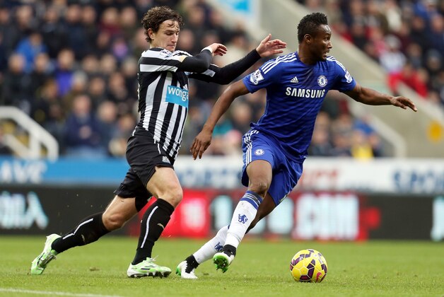 Chelsea's John Obi Mikel, right, vies for the ball with Newcastle United's Daryl Janmaat during their English Premier League soccer match at St James' Park, Newcastle, England, Saturday, Dec. 6, 2014. (AP Photo/Scott Heppell)