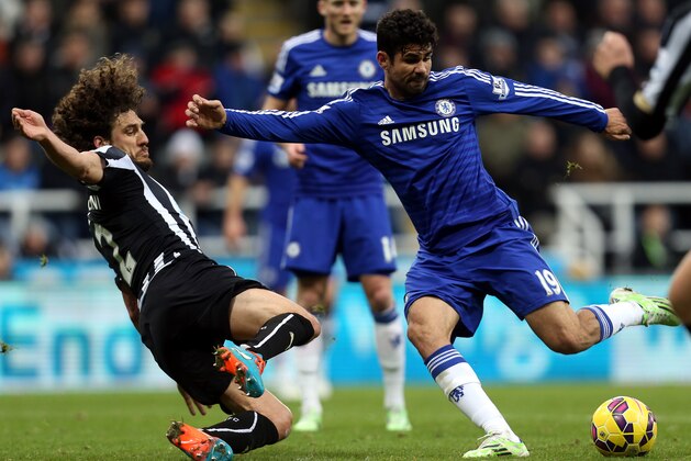Chelsea's Diego Costa, right, has a shot towards goal past Newcastle United's captain Fabricio Coloccini, left, during their English Premier League soccer match at St James' Park, Newcastle, England, Saturday, Dec. 6, 2014. (AP Photo/Scott Heppell)