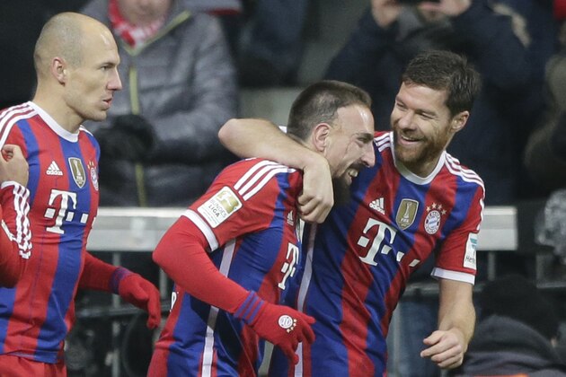 Bayern's Franck Ribery from France, center, celebrates with teammate Bayern’s Xabi Alonso from Spain, right, after scoring his side's opening goal during the German first division Bundesliga soccer match between FC Bayern and Bayer Leverkusen 04 in the Allianz Arena in Munich, Germany, on Saturday, Dec. 6, 2014. (AP Photo/Matthias Schrader)