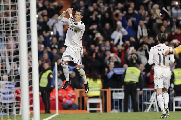 Real Madrid’s Cristiano Ronaldo, left, celebrates as his team mate Gareth Bale runs towards him after scoring a goal during a Spanish La Liga soccer match between Real Madrid and Celta de Vigo at the Bernabeu stadium in Madrid, Spain, Saturday, Dec. 6, 2014 . (AP Photo/Daniel Ochoa de Olza)