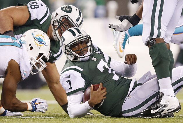 New York Jets quarterback Geno Smith (7) reacts after being sacked by the Miami Dolphins during the fourth quarter of an NFL football game, Monday, Dec. 1, 2014, in East Rutherford, N.J. (AP Photo/Kathy Willens)