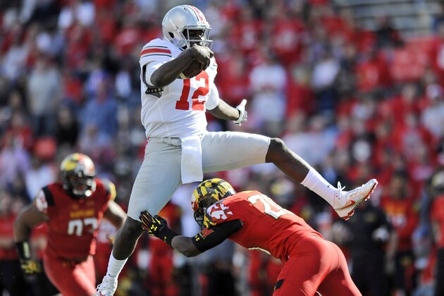 FILE - In this Oct. 4, 2014, file photo, Ohio State's quarterback Cardale Jones leaps over Maryland's safety Anthony Nixon during the second half of an NCAA college football game in College Park, Md. After Ohio State lost quarterback Braxton Miller in the preseason to a shoulder injury, J.T. Barrett had a big year before breaking his ankle against Michigan. Now the Buckeyes turn to Cardale Jones in the Big Ten title game against Wisconsin on Saturday, Dec. 6, 2014. (AP Photo/Gail Burton, File)