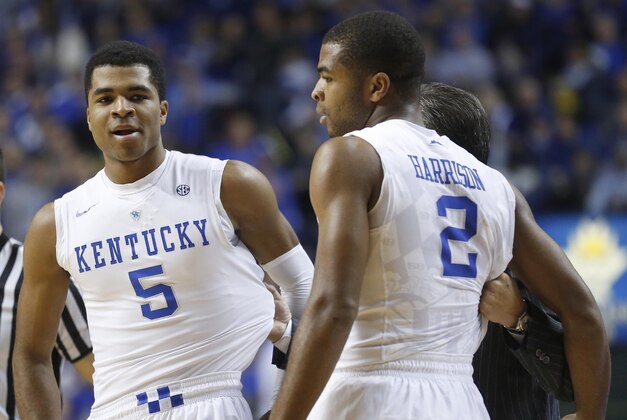 Dec 5, 2014; Lexington, KY, USA; Kentucky Wildcats head coach John Calipari (C) talks with guard Aaron Harrison (2) and guard Andrew Harrison (5) during the game against the Texas Longhorns in the second half at Rupp Arena. The Wildcats won 63-51. Mandatory Credit: Mark Zerof-USA TODAY Sports