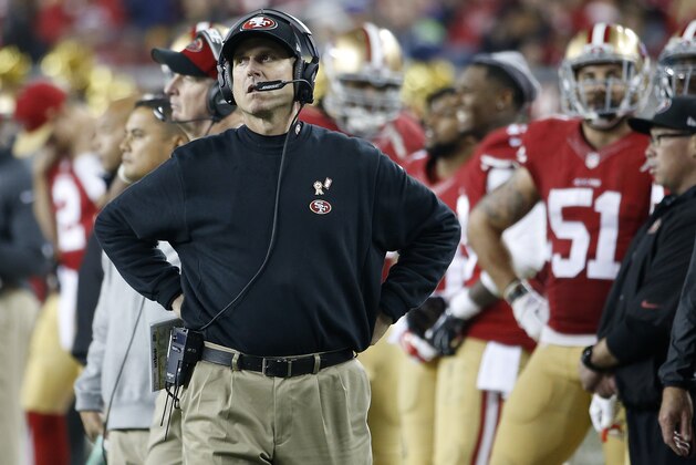 San Francisco 49ers head coach Jim Harbaugh stands on the sideline during the fourth quarter of an NFL football game against the Seattle Seahawks in Santa Clara, Calif., Thursday, Nov. 27, 2014. The Seahawks won 19-3. (AP Photo/Tony Avelar)