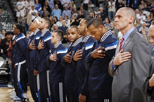 DALLAS, TX -  DECEMBER 5: Dallas Mavericks bows their heads during the national anthem before the game against the Phoenix Suns on December 5, 2014 at American Airlines Center in Dallas, Texas. NOTE TO USER: User expressly acknowledges and agrees that, by downloading and or using this Photograph, user is consenting to the terms and conditions of the Getty Images License Agreement. Mandatory Copyright Notice: Copyright 2014 NBAE (Photo by Glenn James/NBAE via Getty Images)