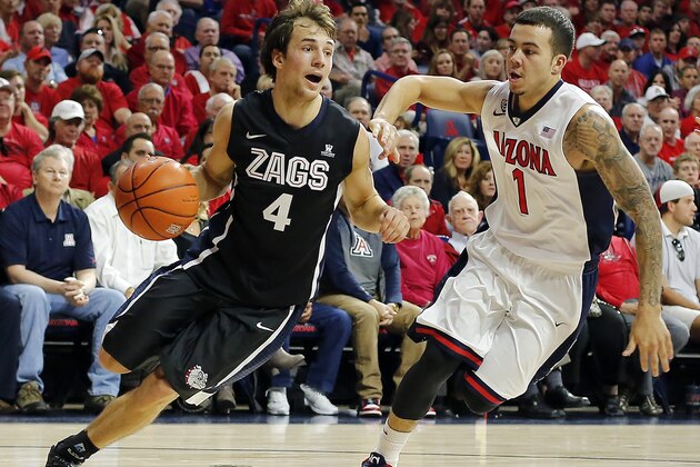 Gonzaga guard Kevin Pangos (4) drives on Arizona guard Gabe York (1) during the first half of an NCAA college basketball game, Saturday, Dec. 6, 2014, in Tucson, Ariz. (AP Photo/Rick Scuteri)