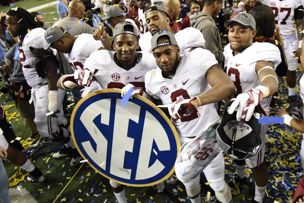 Dec 6, 2014; Atlanta, GA, USA; Alabama Crimson Tide wide receiver DeAndrew White (2) and his teammates celebrate with the SEC sign after the 2014 SEC Championship Game against the Missouri Tigers at the Georgia Dome. Alabama defeated Missouri 42-13. Mandatory Credit: Dale Zanine-USA TODAY Sports