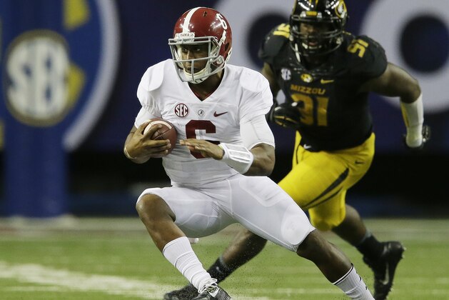 Alabama quarterback Blake Sims (6) runs past Missouri defensive lineman Charles Harris (91) during the second half of the Southeastern Conference championship NCAA college football game, Saturday, Dec. 6, 2014, in Atlanta. (AP Photo/Jamie Martin)