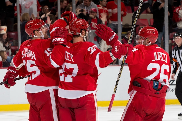 DETROIT, MI - DECEMBER 4:  Danny DeKeyser #65, Riley Sheahan #15 and Tomas Jurco #26 of the Detroit Red Wings congratulate teammate Kyle Quincey #27 of the Detroit Red Wings on his goal during a NHL game against the Dallas Stars on December 4, 2014 at Joe Louis Arena in Detroit, Michigan. The Wings defeated the Stars 5-2 (Photo by Dave Reginek/NHLI via Getty Images)