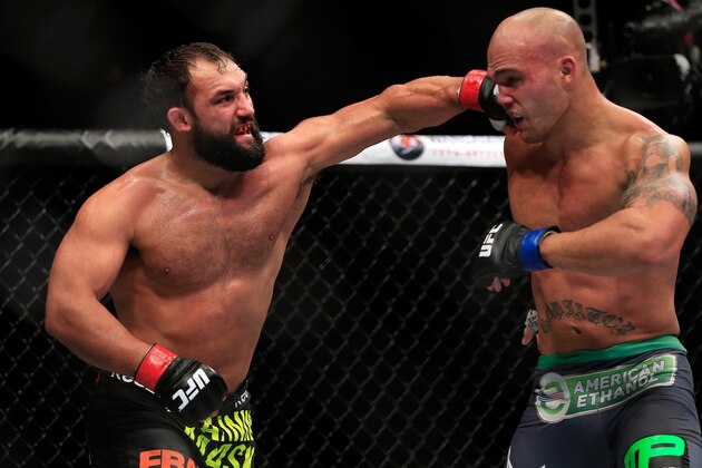 LAS VEGAS, NV - DECEMBER 06:  Johny Hendricks punches Robbie Lawler in their welterweight title fight during the UFC 181 event at the Mandalay Bay Events Center on December 6, 2014 in Las Vegas, Nevada.  (Photo by Alex Trautwig/Getty Images)