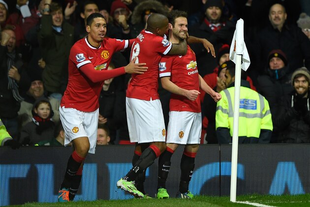 MANCHESTER, ENGLAND - DECEMBER 02:  Juan Mata of Manchester United (R) celebrates scoring his team's second goal with his team-mates Chris Smalling (L) and Ashley Young during the Barclays Premier League match between Manchester United and Stoke City at Old Trafford on December 2, 2014 in Manchester, England.  (Photo by Mike Hewitt/Getty Images)